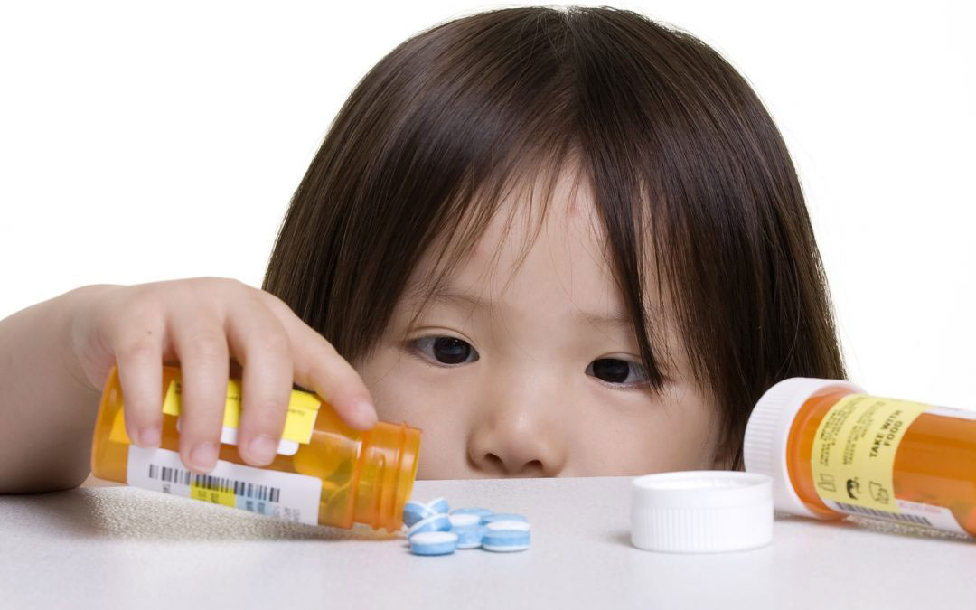 small child with a prescription bottle